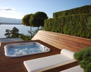 Outdoor hot tub installation on a patio in the spring.