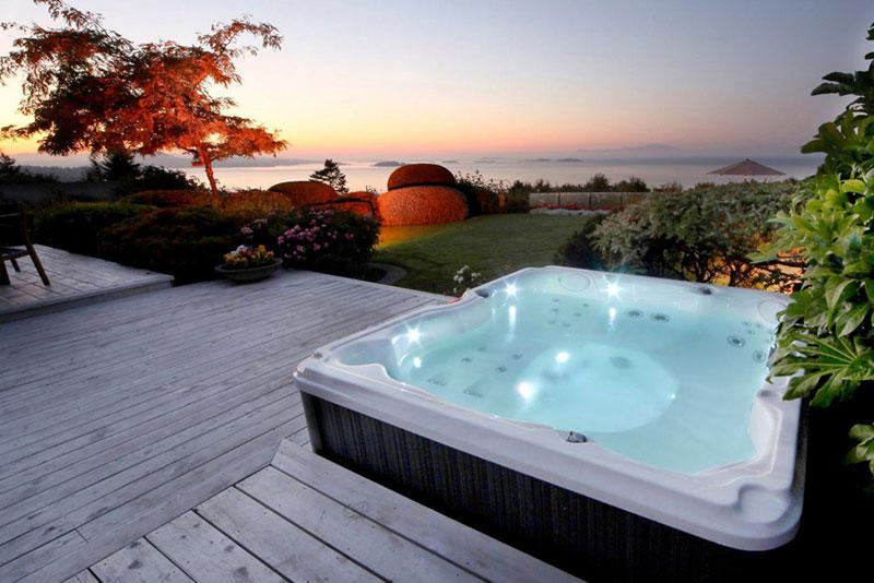 Outdoor hot tub installed on a deck foundation.