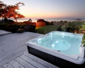 Outdoor hot tub installed on a deck foundation.