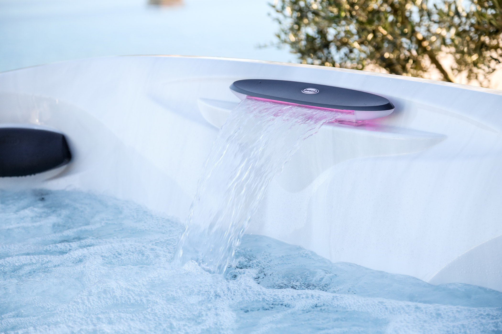 Clean water flowing through a built-in waterfall in a Jacuzzi Hot Tub.