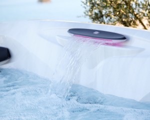 Clean water flowing through a built-in waterfall in a Jacuzzi Hot Tub.