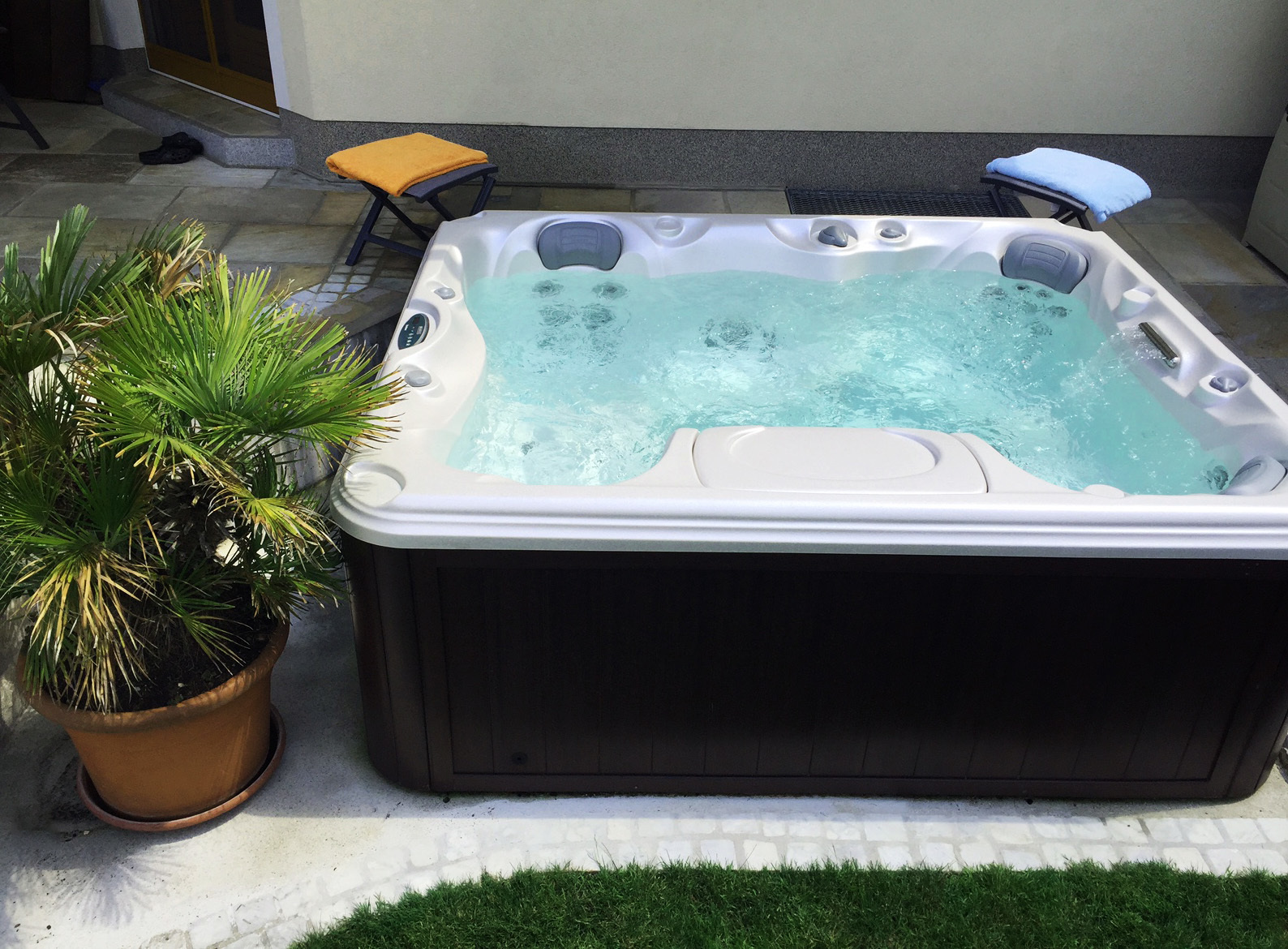 Outdoor hot tub installation on a patio in the spring.