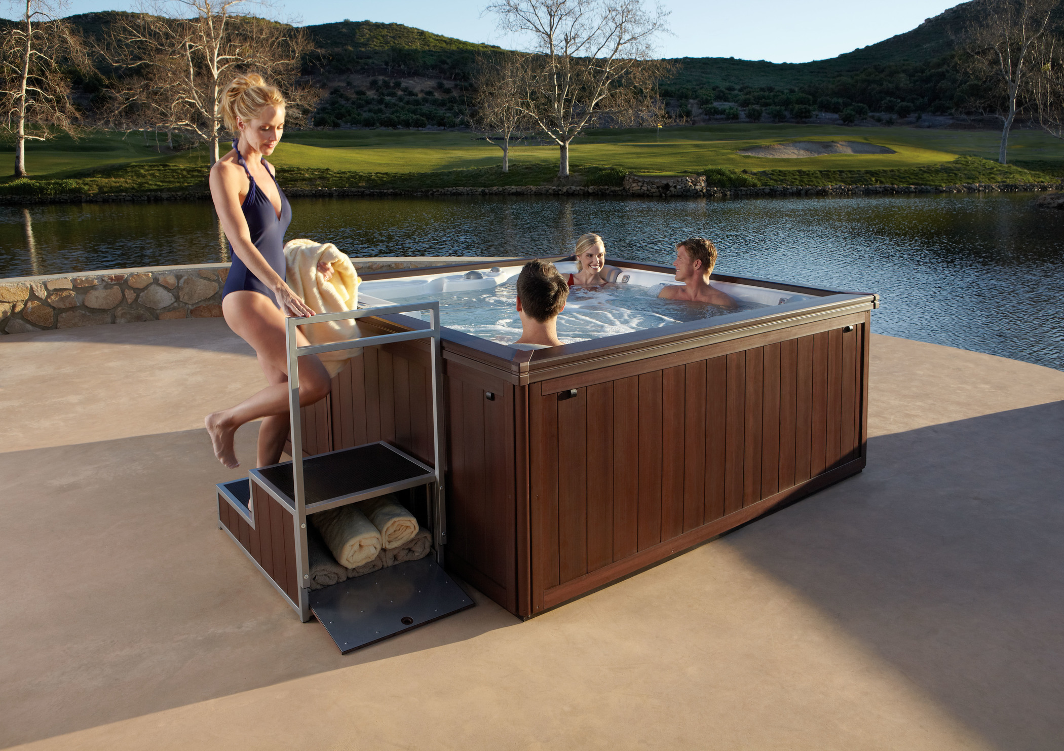 Family relaxing in the hot tub outside.