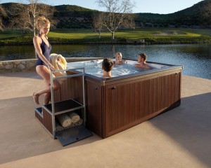 Family relaxing in the hot tub outside.